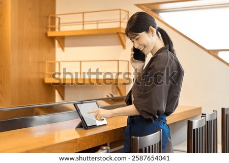 Restaurant employee managing using a tablet