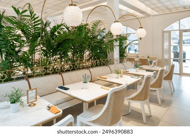 The restaurant features a modern and elegant design with a focus on natural elements. - Powered by Shutterstock