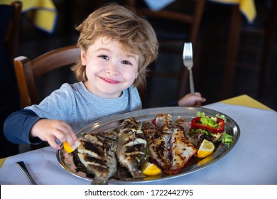 Restaurant Food At Home. Cooking During Quarantine. The Tradition Of Family Dinners At Home During Lockdown. The Boy Eats Fish At The Table. Sea Dinner.