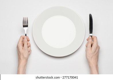 Restaurant And Food Theme: The Human Hand Show Gesture On An Empty White Plate On A White Background In Studio Isolated Top View