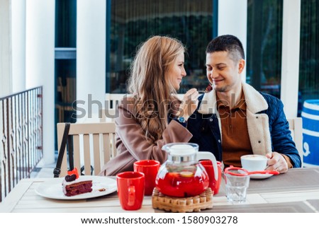 restaurant. a guy with a girl drink hot coffee and tea