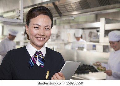 Restaurant Hostess In Industrial Kitchen