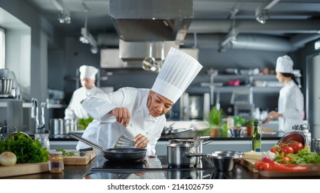 Restaurant Kitchen: Black Female Chef Cooking Delicious And Traditional Authentic Food, Uses Oil On Pan Getting Ready To Fry Organic Free Range Meat Patty. Preparing Gourmet Dishes. Wide Shot