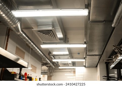 Restaurant kitchen ceiling. Ventilation system in cafe. Ensuring air circulation for food establishments. Galvanized ventilation pipes in confectionery shop. Ventilation equipment for restaurants