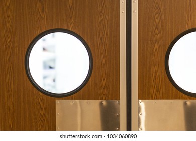 Restaurant Kitchen Entrance. Closed Wooden Double Door With Round Porthole Style Window.  Cafe Lowdown Inside Secret Information Concept