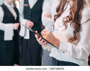 restaurant manager and his staff in kitchen. interacting to head chef in commercial kitchen - Powered by Shutterstock