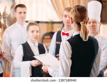 restaurant manager and his staff in kitchen. interacting to head chef in commercial kitchen - Powered by Shutterstock