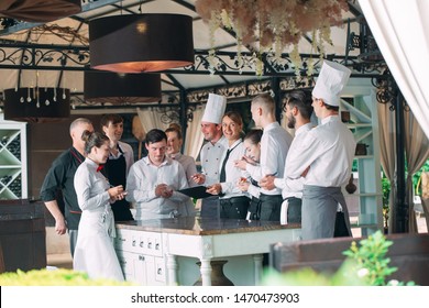 Restaurant Manager And His Staff In Terrace. Interacting To Head Chef In Restaurant