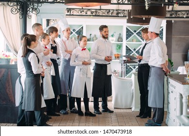 Restaurant Manager And His Staff In Terrace. Interacting To Head Chef In Restaurant