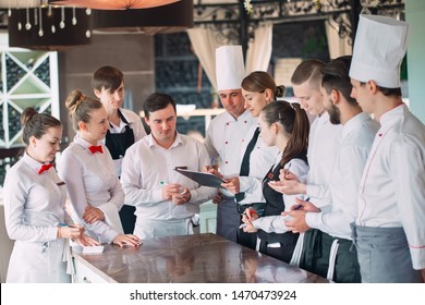 Restaurant Manager And His Staff In Terrace. Interacting To Head Chef In Restaurant