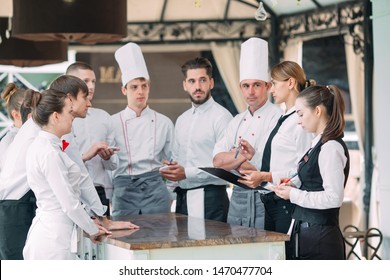 Restaurant Manager And His Staff In Terrace. Interacting To Head Chef In Restaurant