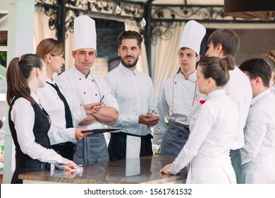 Restaurant Manager And His Staff In Terrace. Interacting To Head Chef In Restaurant