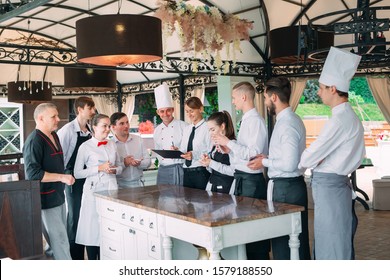 Restaurant Manager And His Staff In Terrace. Interacting To Head Chef In Restaurant