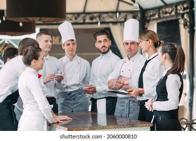 Restaurant manager and his staff in terrace. interacting to head chef in restaurant - Powered by Shutterstock