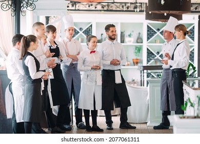 Restaurant Manager And His Staff In Terrace. Interacting To Head Chef In Restaurant