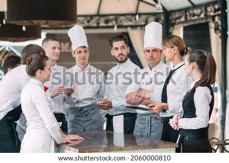 Restaurant manager and his staff in terrace. interacting to head chef in restaurant Сток-фото © 