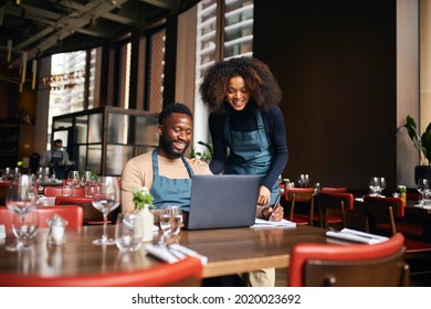Restaurant managers working with laptop