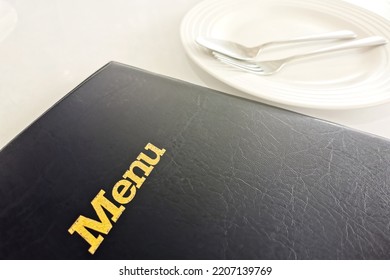 Restaurant Menu Book On The Table With Empty Dish