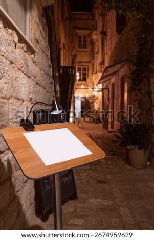 Restaurant Menu Mockup with Empty Space, Outdoor Evening Scene with Bokeh Lights in Old Town