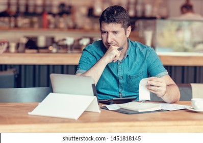 Restaurant owner checking monthly reports on a tablet, bills and expenses of his small business. Start-up entrepreneur concerned about financial reports - Shutterstock ID 1451818145