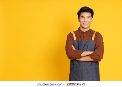 Restaurant owner sme Asian man smilling with arms crossed isolated on yellow background - Powered by Shutterstock