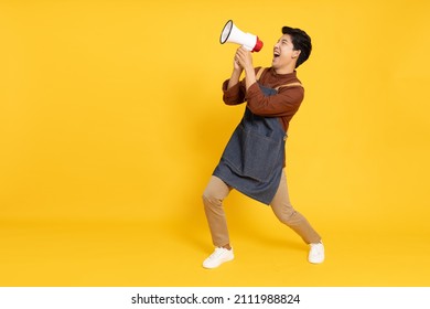 Restaurant Owner Sme Young Asian Man Holding Megaphone Isolated On Yellow Background, Speaker And Announce Concept