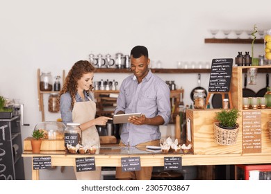 Restaurant owners, tablet and teamwork of people, manage orders and discussion in store. Waiters, black man and happy woman in cafe with technology for inventory, stock check and managing sales. - Powered by Shutterstock