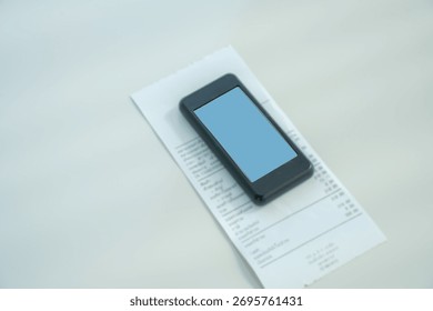 Restaurant queue pager placed on receipt on wooden table. Perfect for concepts of food service technology, customer waiting system, smart restaurant operations, and digital order notification tools.
