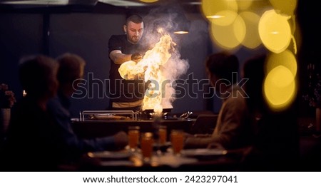 In a restaurant setting, a professional chef presents a sizzling steak cooked over an open flame, while an European Muslim family eagerly awaits their iftar meal during the holy month of Ramadan