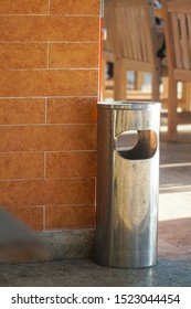 Restaurant Side Hole Trash Bin Spot At The Corner Of The Brick Wall. A Metal Trash Can In The Corner Of The Cafe.