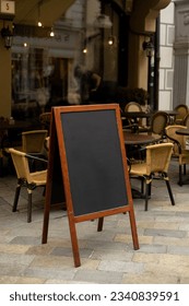 Restaurant sidewalk chalkboard sign board. Old Blak Signboard on the street. Blank store signage sign design mockup isolated