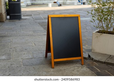 Restaurant sidewalk chalkboard sign board. Old Black Signboard on the street. Blank store signage sign design mockup isolated. . Blackboard advertising sign or customer stopper at sidewalk cafe