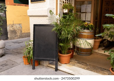 Restaurant sidewalk chalkboard sign board. Old Signboard with pots on the street. Blank store signage sign design mockup isolated. Blackboard advertising sign or customer stopper at sidewalk cafe