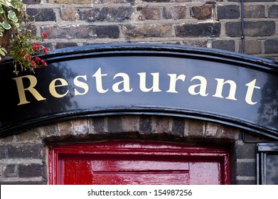 Restaurant Sign Above Red Door