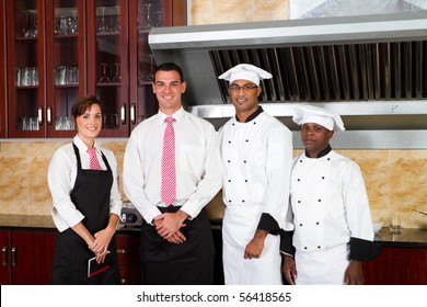 restaurant staff inside industrial kitchen - Powered by Shutterstock