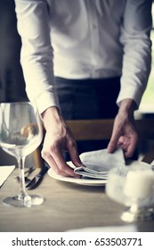 Restaurant Staff Setting Table In Restaurant For Reception