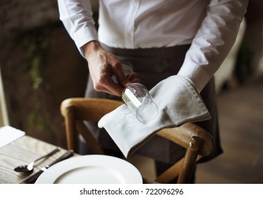 Restaurant Staff Setting Table In Restaurant For Reception