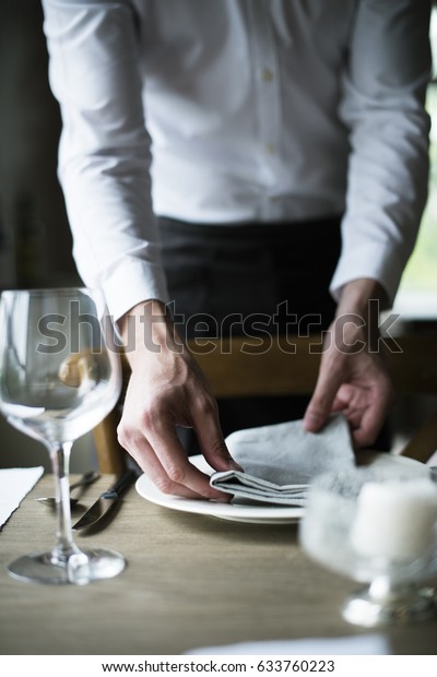 Restaurant Staff Setting Table in Restaurant\
for Reception