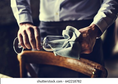 Restaurant Staff Wiping Glass On Table Setting Service For Reception