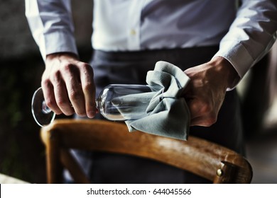 Restaurant Staff Wiping Glass On Table Setting Service For Reception