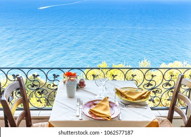 Restaurant Table Overlooking The Sea On The Amalfi Coast In Italy.