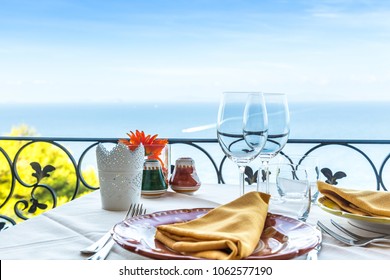 Restaurant Table Overlooking The Sea On The Amalfi Coast In Italy.