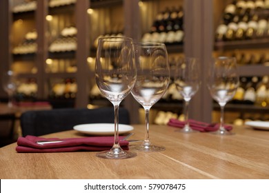 Restaurant Table With Wine Cellar In Blurred Background