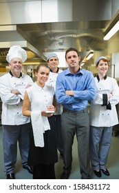 Restaurant Team Posing Together In A Kitchen 