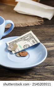 Restaurant Tips Or Gratuity, American Banknotes And Coins On Plate