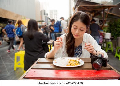 Restaurant Tourists Eating At Outdoor Market Cafe. Summer Travel People Eating Healthy Food At Lunch During Holidays In Bangkok, Thailand. Asian Chinese Young Adults Traveler.