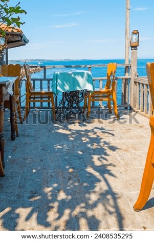 Restaurant in the town of Sozopol, Bulgaria. Vacation time. Beautiful weather. The coastline in the background.