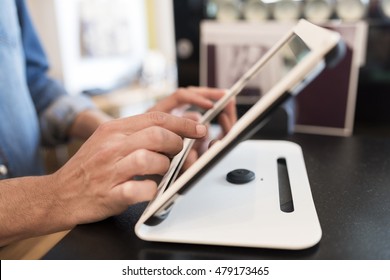 In A Restaurant The Waiter Prepares The Bill On Computer POS Tablet Pc. The Waiter Takes The Order On Digital Tablet