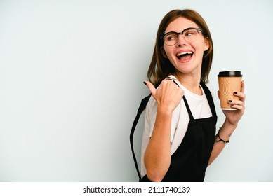 Restaurant Waiter Woman Holding A Take Away Coffee Isolated On Blue Background Points With Thumb Finger Away, Laughing And Carefree.