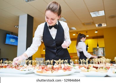 Restaurant Waitress Serving Table With Food